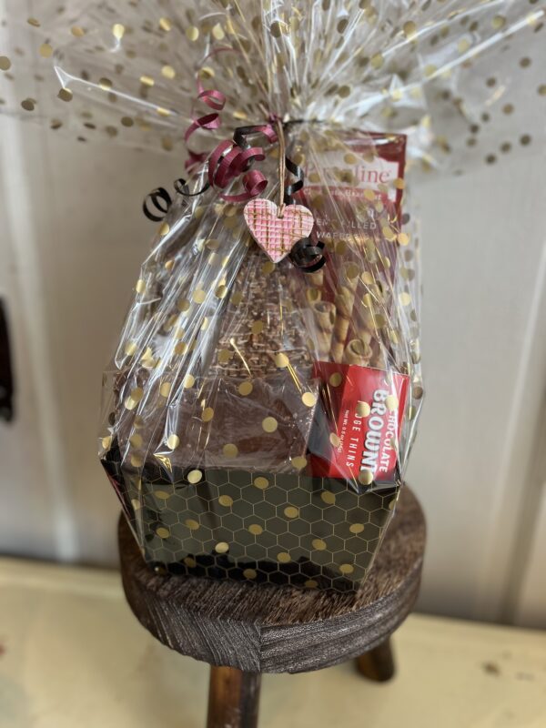 Basket of Valentine sweets including chocolate pretzels, fudge, maple popcorn, cookies and more.